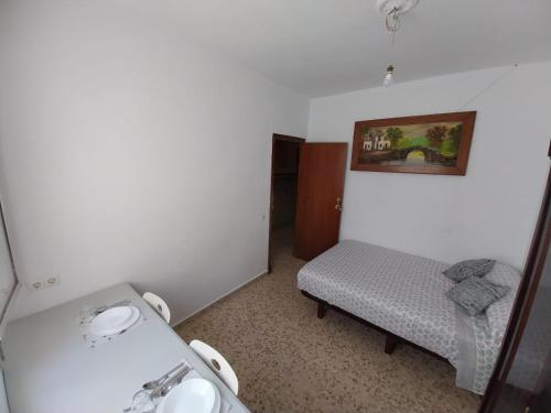 a small room with two beds and a sink at Habitación D doble economica in Cantillana