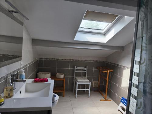 a bathroom with a sink and a skylight at Gite La Baraque in Najac