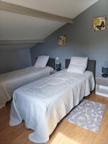two beds sitting next to each other in a bedroom at Gite La Baraque in Najac