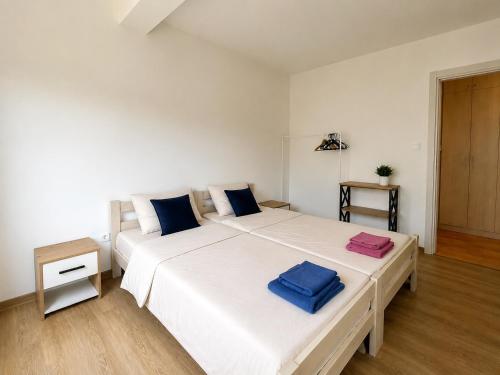 a bedroom with a large white bed with two towels on it at Comfort Apartment Becici in Bečići