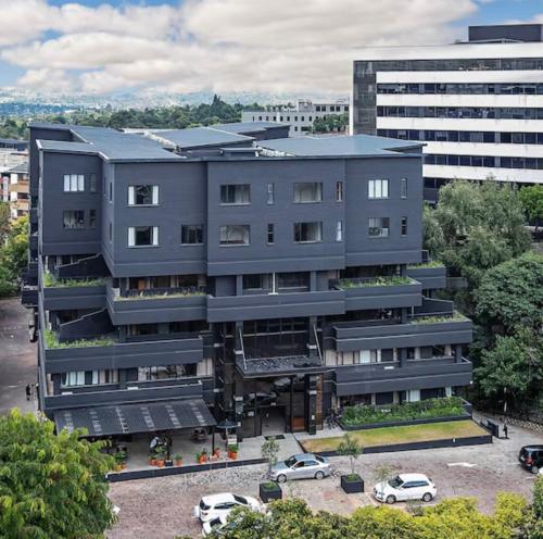 an apartment building with cars parked in a parking lot at Sandton CBD apartment in Johannesburg