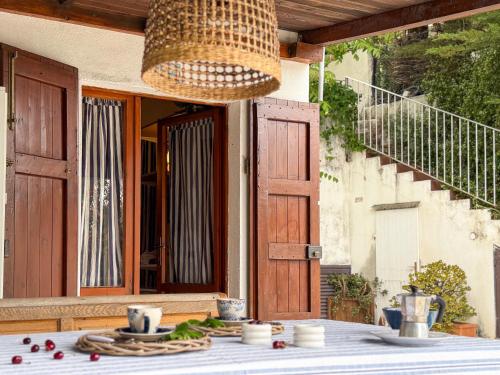 a table with a plate of food on a porch at Fuga d'Amore - HelloElba in Portoferraio