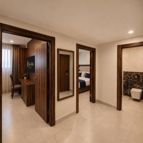 a corridor of a hotel room with a bedroom at Ten Hills Hotel in Amman