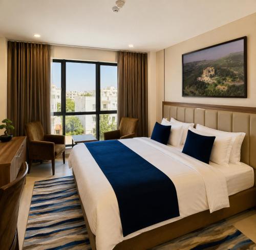 a hotel room with a bed and a large window at Ten Hills Hotel in Amman