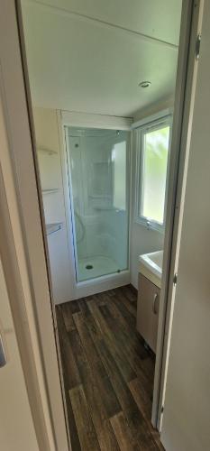 a bathroom with a glass shower and a sink at Camping l'Or Bleu in Barrême