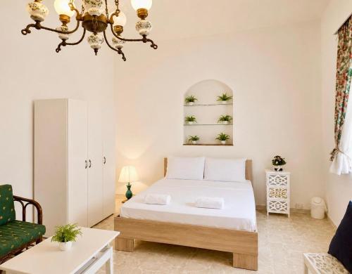 a bedroom with a bed and a chandelier at Seaview luxury flat 4 bedrooms in Sliema