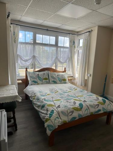 a bedroom with a bed in front of a window at Clarendon Lodge - accommodation only in Skegness