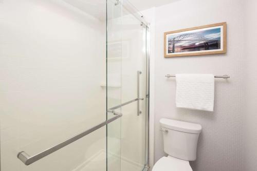 a bathroom with a toilet and a glass shower at Cape Cod Family Resort and Parks in West Yarmouth