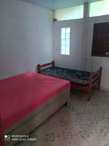 a bedroom with two beds and a window at CHÁCARA recanto das nuvens 2 in Arujá