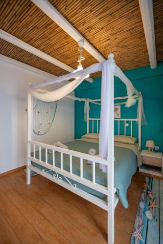 a bedroom with two bunk beds and a wooden ceiling at Kalypso Rental Apartment in Myloi