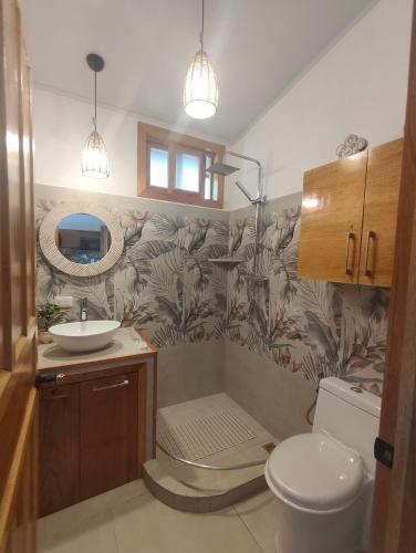 a bathroom with a sink and a toilet at Caribbean Lory in Puerto Viejo