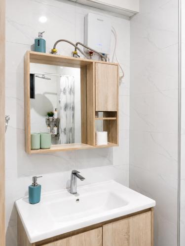 a bathroom with a sink and a mirror at Casa Liora Studio by UN & Two Rivers in Nairobi