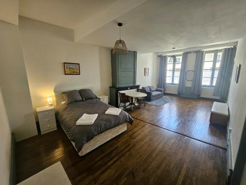 a bedroom with a bed and a living room at Private Apartment in Rochechouart
