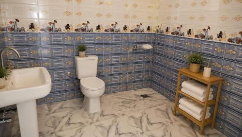a bathroom with a toilet and a sink at Quiet Mini Villa with Garden in Luxor