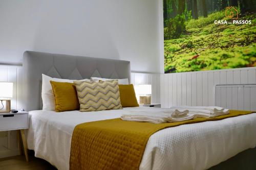 a bedroom with a large bed with a yellow blanket at Casa dos Passos 1 in Guarda