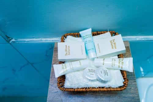 a wicker basket with towels and books next to a pool at Ngolu Hotel and Residences in Kitui