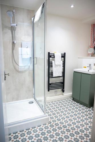 a bathroom with a shower and a sink at Squirrel Away Apartments in Crieff