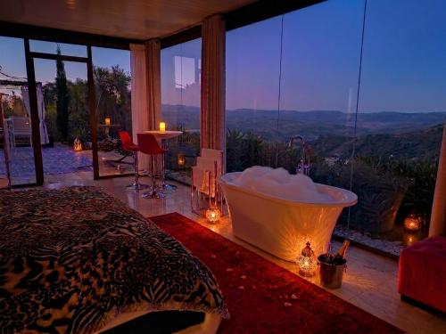 a bedroom with a bath tub in a room with a view at DDG Retreat in Casares