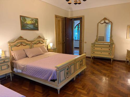 a bedroom with a bed and a dresser and a mirror at Cascinotto Stella Silvia in Piossasco
