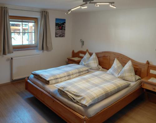 a bedroom with a bed with pillows on it at Ferienwohnung Kollerlehen in Bischofswiesen