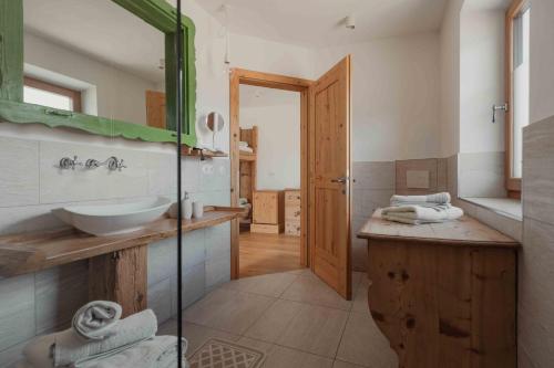 a bathroom with a sink and a mirror at Bucherhof in Marlengo