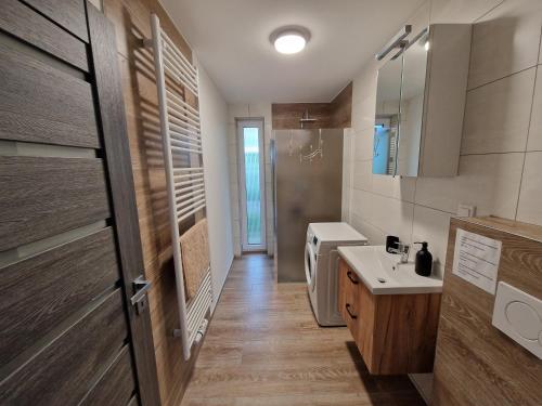 a bathroom with a sink and a toilet and a door at Vejminek 87 in Červená Třemešná