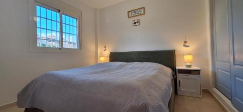 a bedroom with a bed and a window at A & G Casares Costa in San Luis de Sabinillas