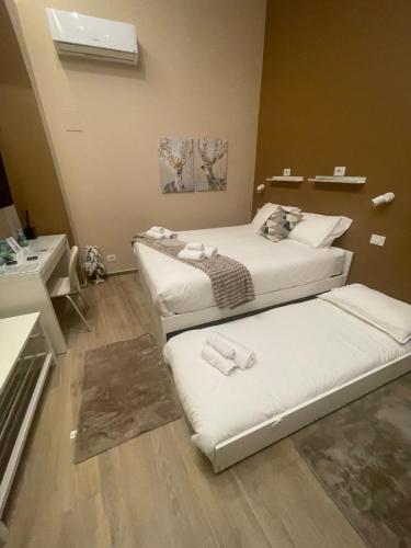 a room with two beds and a sink at Mado Suite 112 in Bari