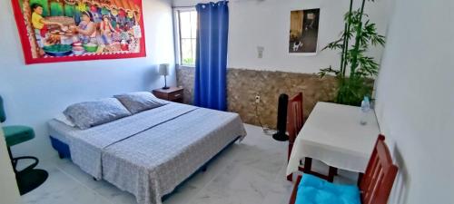 a bedroom with a bed and a desk in it at Playa El Obispo A La Marea building La Libertad in La Libertad