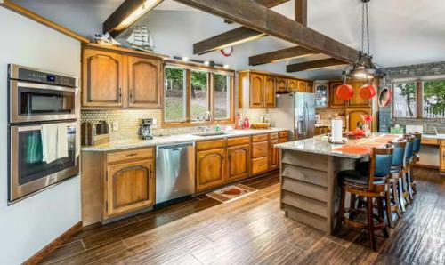 a kitchen with wooden cabinets and stainless steel appliances at Unforgettable Lake Memories in Lake Ozark