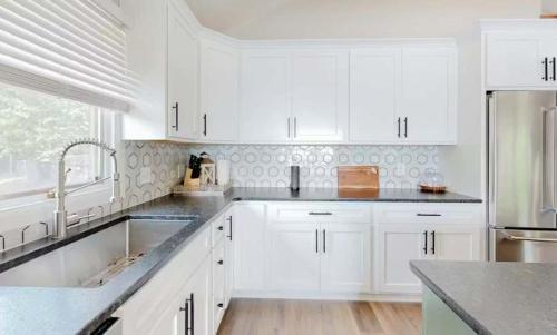 a white kitchen with white cabinets and a sink at Lake Ozarks in Rocky Mount