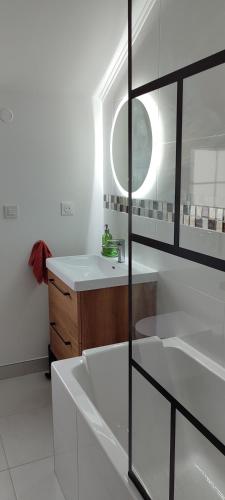 a white bathroom with a sink and a mirror at Le Point Relais in Fumay