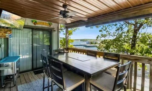 a dining room with a table and chairs and a large window at Full Moon Condo in Lake Ozark