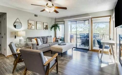a living room with a couch and a ceiling fan at Full Moon Condo in Lake Ozark