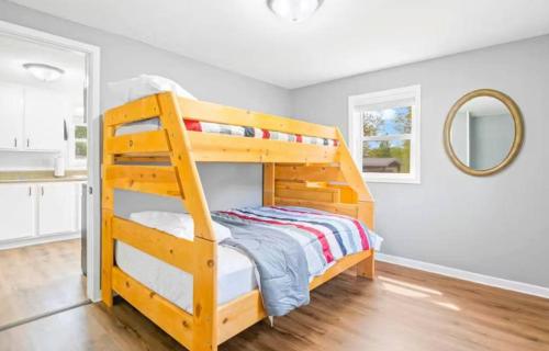 a bedroom with a wooden bunk bed and a mirror at Eternal Sunrises in Sunrise Beach