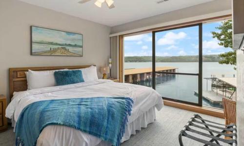a bedroom with a bed and a large window at Pelican Bay Getaway in Lake Ozark