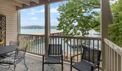 a balcony with a table and chairs and a view of the water at Pelican Bay Getaway in Lake Ozark