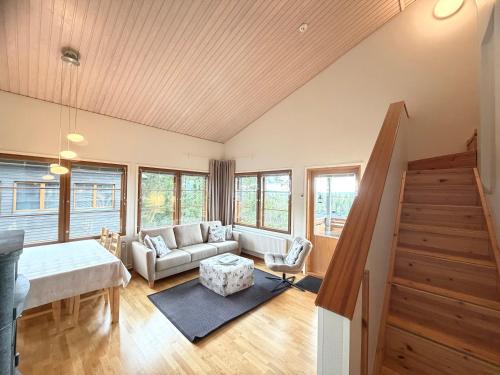 a living room with a couch and a table at Ruka Center Chalet 3B4 - Ski-In Ski-Out - All services nearby - AC - Fireplace - Wifi - Own parking place in Ruka