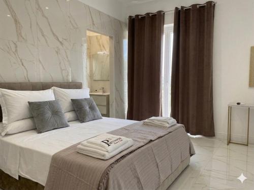 a bedroom with a large bed in a room at Partenopeo Rooms & Suite in Nola