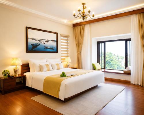 a bedroom with a large bed and a large window at Happy Life Memories Hoi An Hotel & Spa in Hoi An