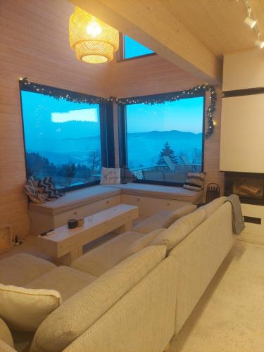 a living room with a couch and a large window at GOLaskowa in Laskowa
