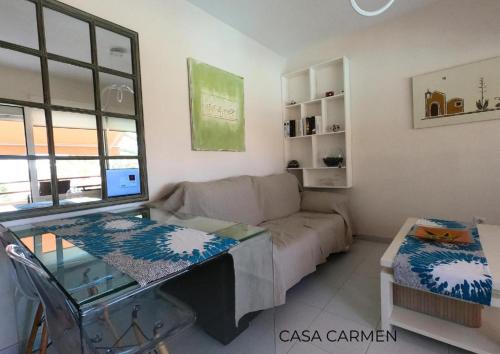 a living room with a couch and a table at Pool View & Terrace Apartments in Corralejo