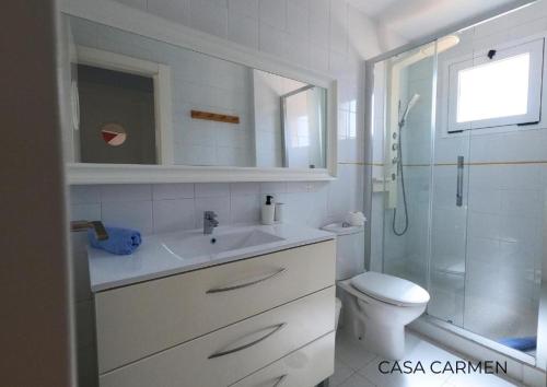 a bathroom with a toilet and a sink and a shower at Pool View & Terrace Apartments in Corralejo