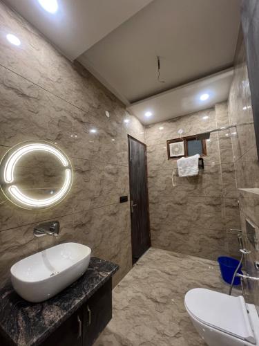 a bathroom with a sink and a mirror at Starlight villa in Ghaziabad