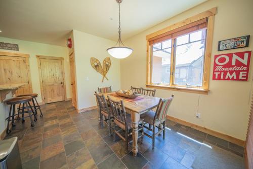 a dining room with a wooden table and chairs at Settlers Creek 6514 by SummitCove Lodging in Colorado in Keystone