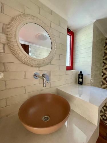 a bathroom with a sink and a mirror at Ahiri traditional cottage in Galatás