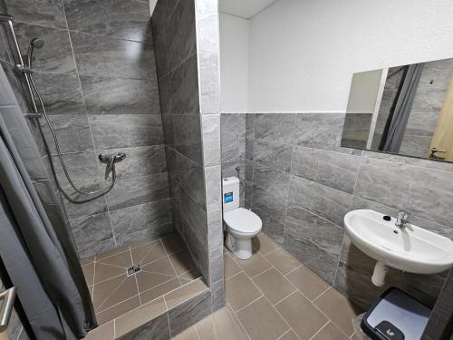 a bathroom with a shower and a toilet and a sink at JOPEL ubytovanie v súkromí in Slovenské ďrmoty