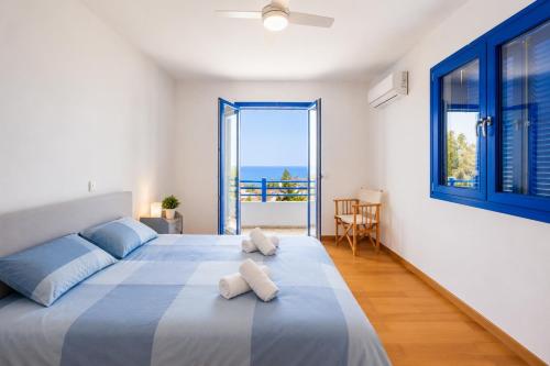 a bedroom with a large bed with a view of the ocean at Villa Eagles Nest in Pachyammos