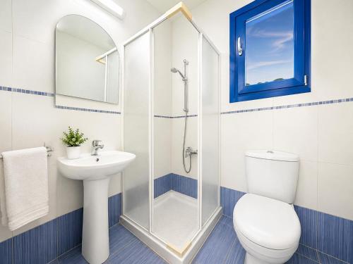 a bathroom with a toilet sink and a shower at Villa Eagles Nest in Pachyammos