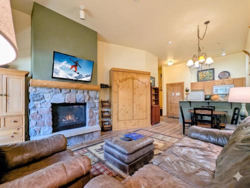 a living room with a couch and a fireplace at Arapahoe Lodge 8105 by SummitCove Lodging in Colorado in Keystone